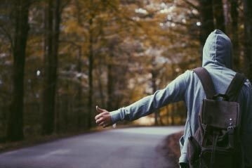 Man Hiking on the Side of the Road